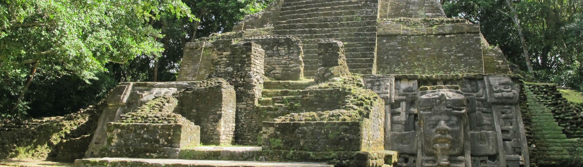 Ancient stone temple ruins surrounded by lush greenery.